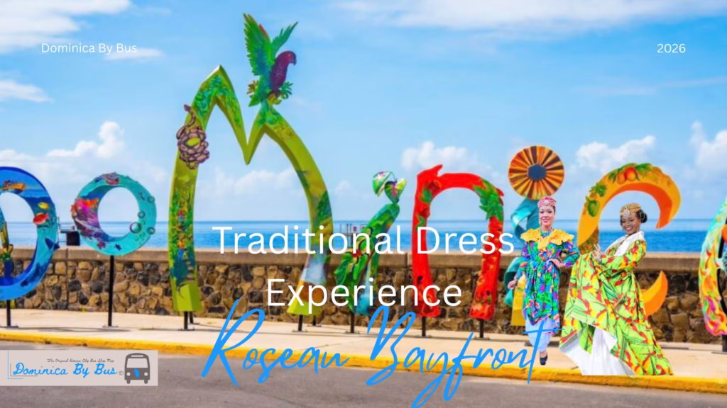 Two women in Traditional Dominican National Dress Wob Dwiyet Standing in Front of DOMINICA sign at Roseau Bayfront.